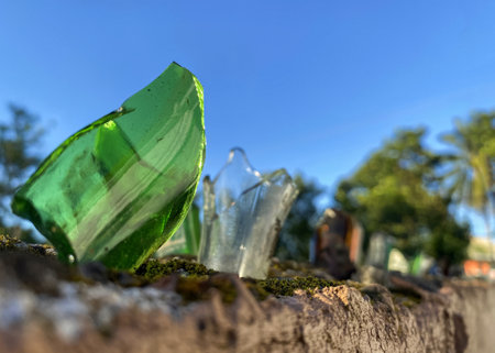 broken glass bottles on the fence to protect private territory from trespassing.の写真素材
