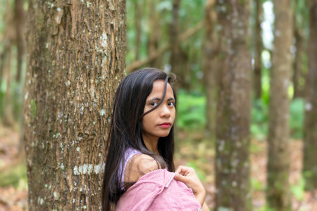 portrait of a young Filipina close-up in the forest.の写真素材