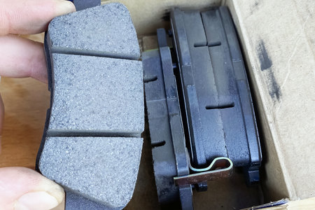 car mechanic took new car brake pads out of the box.の写真素材