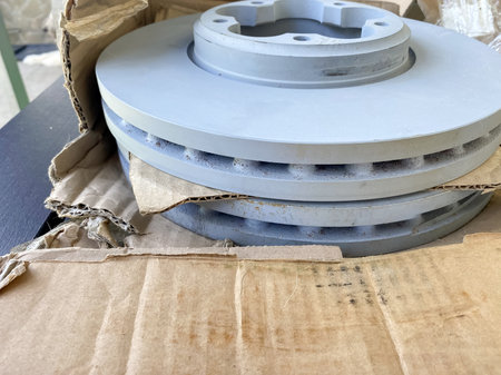 new car brake discs in a cardboard box, spare parts for car repairs.の写真素材