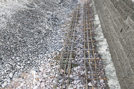metal reinforcement fastened with wire lies on an embankment of crushed stone for pouring concrete.の写真素材