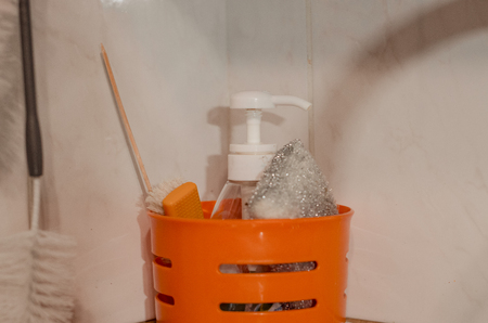 House and room interiors. Kitchen sink with pink rag and dishwashing liquid. Cleaning the house and washingn the dishes concept.の写真素材