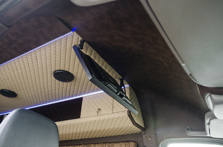 Wide view on interiors of the back of the car. Mild ceiling of the bus. Transport saloon concept.の写真素材