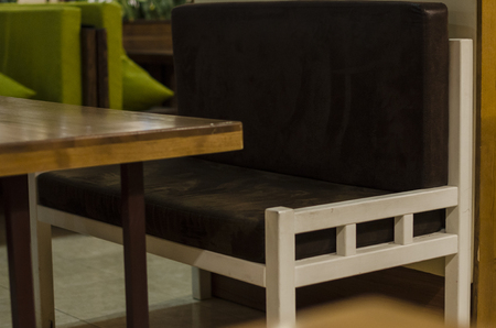 Restaurant interiors close up view. A soft sofa and a wooden table. Place for resting and relaxing concept.の写真素材