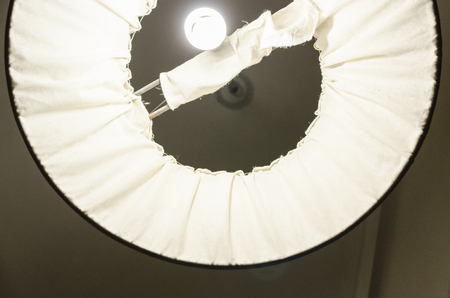 A white lamp with light bulb from the bottom up view. Room lightning concept. House interiors.の写真素材
