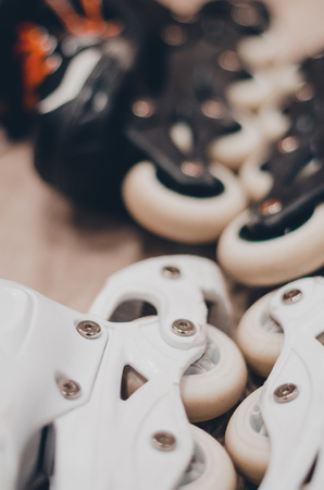 Black and white roller skates for a couple. Wheels close up view. Ready to skate on the roller rink concept.の写真素材