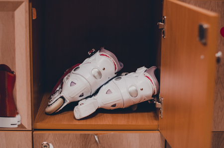 A pair of white roller skates in the wooden shelf close up view. Skating and havng fun concept. Keeping sport equipment in the locker.の写真素材