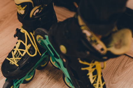 black old roller skates on the roller rink from the top view. Wheels and laces close up view. Ready...