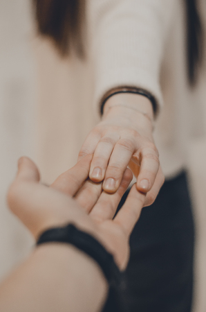 A couple holding hands concept close up view. Follow me my love. A romantic date.の写真素材