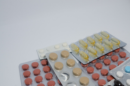 Packings of multicolored medical pills. Medicine concept isolated on the white background. Cure your pain with capsules treatment. Stay healthyの写真素材