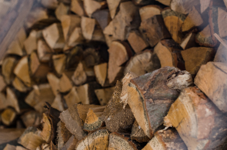 Wood pile reserve for the winter concept. Pile of chopped firewood from trees. Nature background texture of wood.  Wooden logs wall close up view.の写真素材
