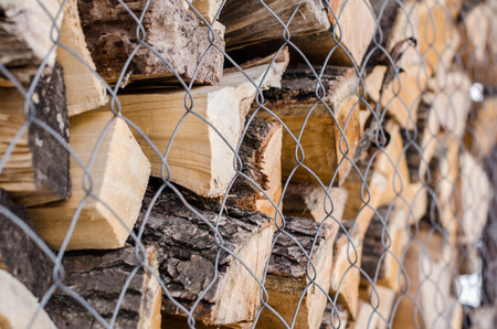 Wood pile reserve for the winter concept. Pile of chopped firewood from trees. Nature background...