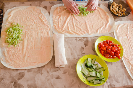 The process of cooking chicken wrap on kitchen table at home concept. Homemade kebab close up. Fresh...