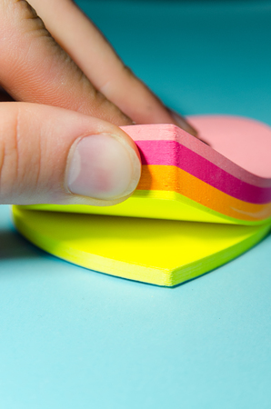 four color block of sticky  notes with clipping path. stickers in the shape of a heart with copy...