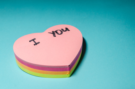 i love written on a sticker in the shape of a heart on the blue background. Leave romantic notes...