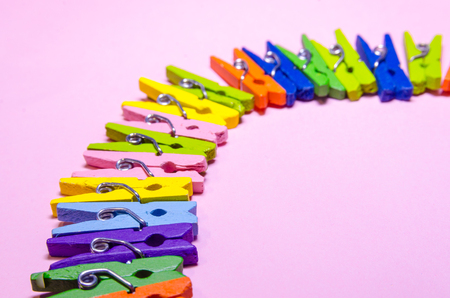 background of a circle made out of colored clothespins or pegs with copy spaceの写真素材
