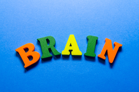 word brain written with colored wooden letters on blue backgroundの写真素材