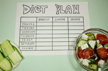 background of blank nutrition plan with copy space, red dumbbell and organic salad. Diet food and loosing weight control concept. Puffed rice bread sandwich.の写真素材