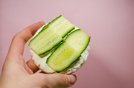 background of puffed rice bread with sliced cucumbers and cream cheese. Organic sandwich with copy space. Diet food conept.の写真素材