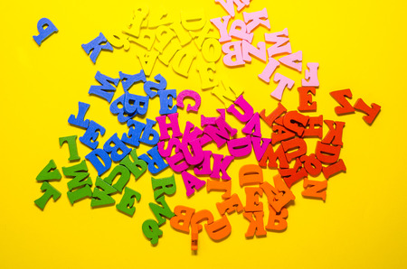 the mess of colored alphabetic letters backgroundの写真素材