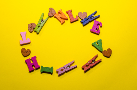 wooden letters and clothes pins in a circle with copy spaceの写真素材