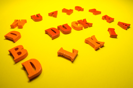 word duck with wooden letters on yellow backgroundの写真素材
