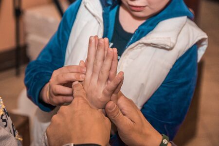 kids comparing hand sizes. who is bigger game conceptの写真素材