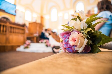 a bouquet of flowers with wedding hall and quests at the backgroundの写真素材