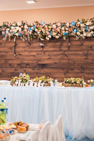 bride and grooms table in the hall where is written loveの写真素材
