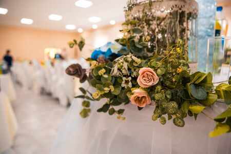 flowers as decor around the table in the wedding hallの写真素材