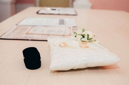wedding rings on little decorated pillow in registry office. wedding moments backgroundの写真素材