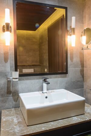 washbasin with mirrow in the hotel bathroomの写真素材