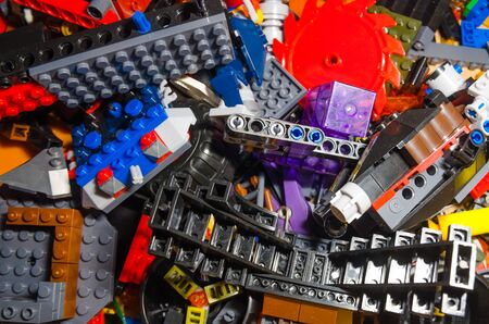colored toy bricks for kids on the floor background. Playing in plastic pieces and elements of constructor toys conceptの写真素材