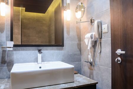washbasin with mirrow in the hotel bathroomの写真素材