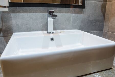 close up view of the white new sink in the bathroomの写真素材