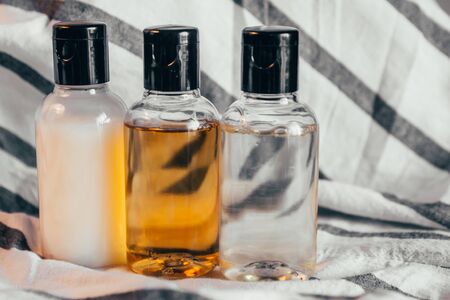 close up view of shower gel, shampoo and body lotion in small travel tubes in hotel bathroomの写真素材