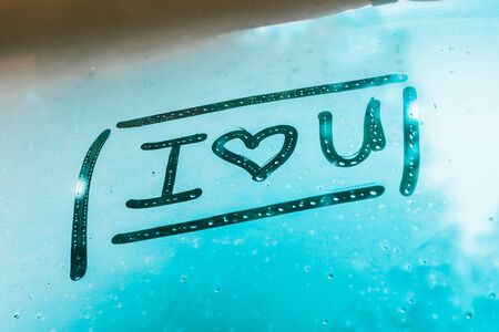 i love you written on foggy window in rainy weather outdoorsの写真素材