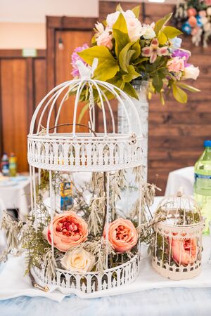 Roses in a cage. wedding flowers as decorの写真素材