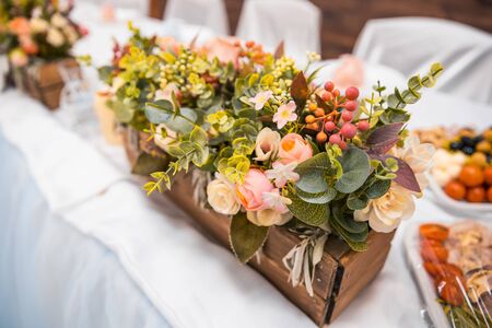 flowers in wooden box on the table as decorの写真素材