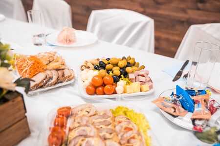 served tables in restaurant with cutlery and fresh dishes. banquet conceptの写真素材