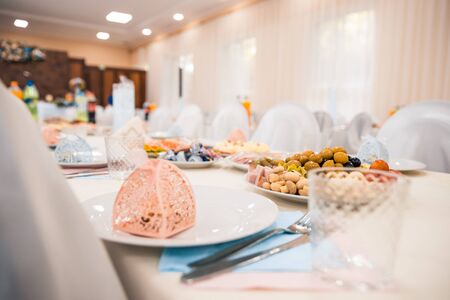 served tables at the wedding with cutlery and fresh dishes. banquet conceptの写真素材