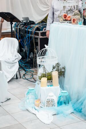 candles and cage with flowers as wedding decorの写真素材