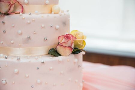 three story wedding cake with roses close upの写真素材