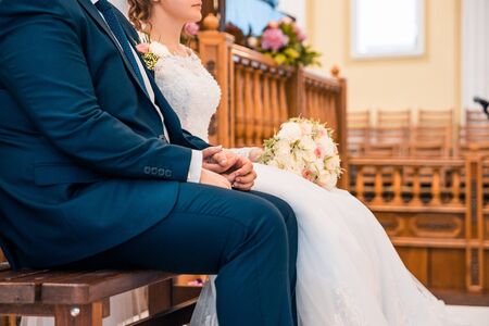 bride and groom sitting together at the weddingの写真素材