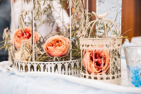Roses in a cage. wedding flowers as decorの写真素材