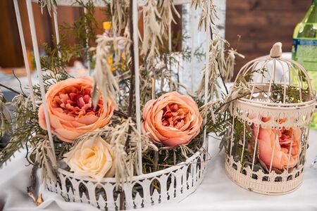 Roses in a cage. wedding flowers as decorの写真素材