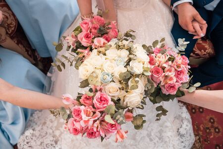 bride and her friends holding flower bouquets at wedding day from top viewの写真素材