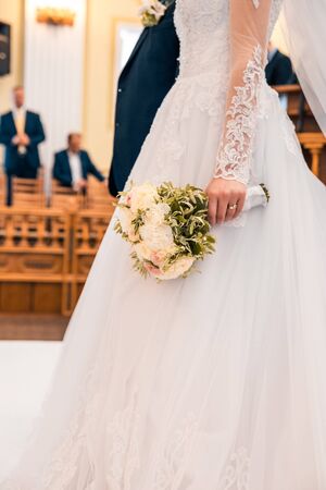 bride holding flowers with blurry background at wedding dayの写真素材