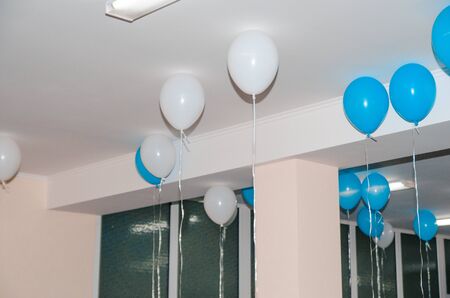 white and blue helium balloons  in the room on a holidayの写真素材