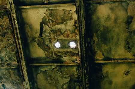 two holes in the old dirty ceiling. house needing repairsの写真素材